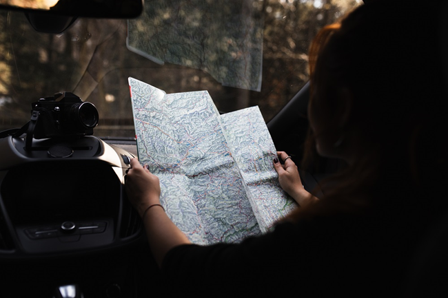 Passenger reading the map in the car
